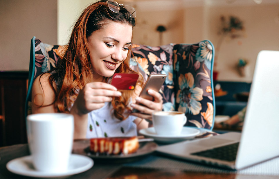 Woman using a debit card for an online purchase