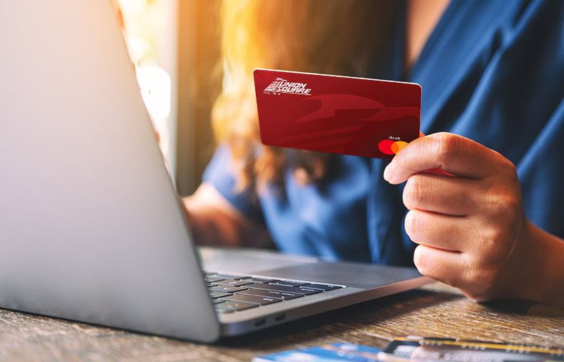 Woman using a debit card for an online purchase