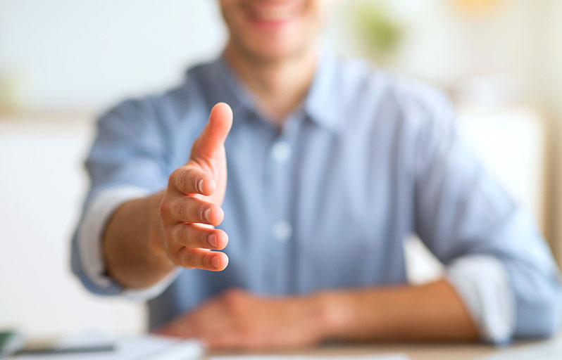 Man reaching out to shake hands