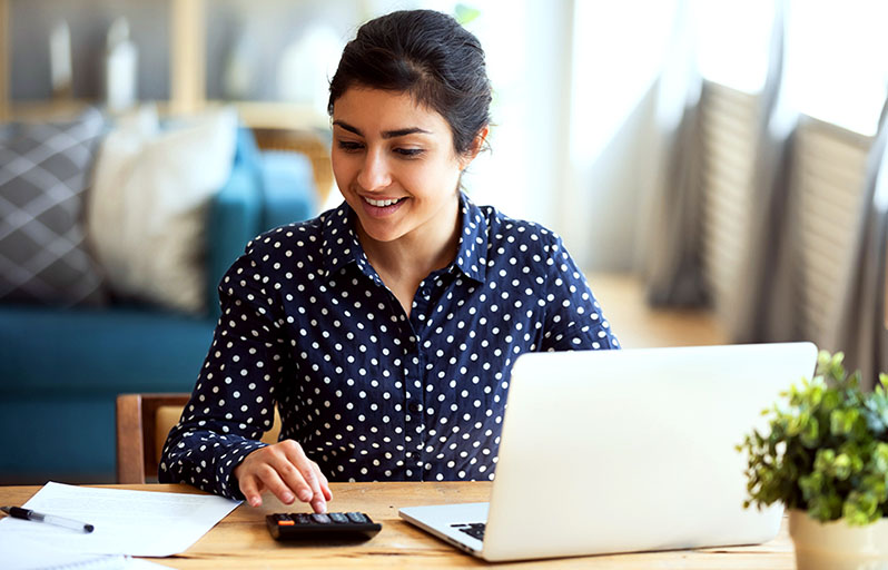 Woman with calculator and laptop