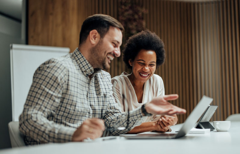 Bi-racial couple looking at laptop