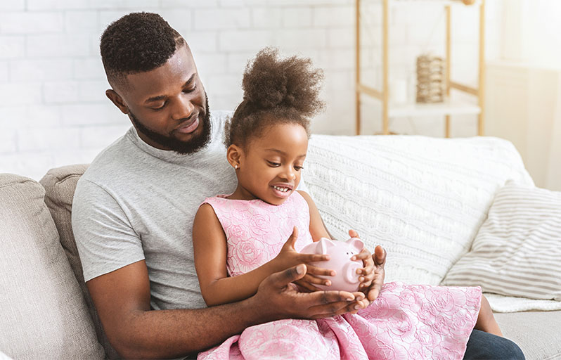 Father with daughter sitting on his lap