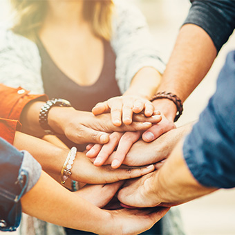 Group of people stacking hands